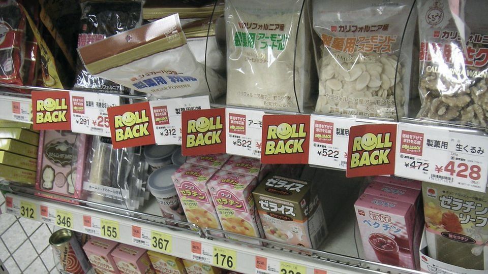 Supermarket shelf with price tags under packaged food