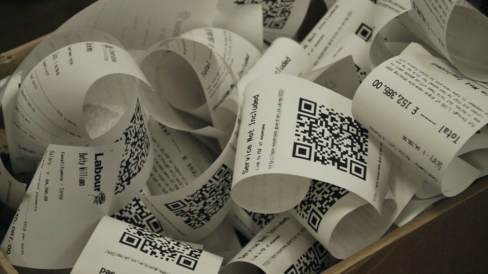 A pile of printed paper receipts