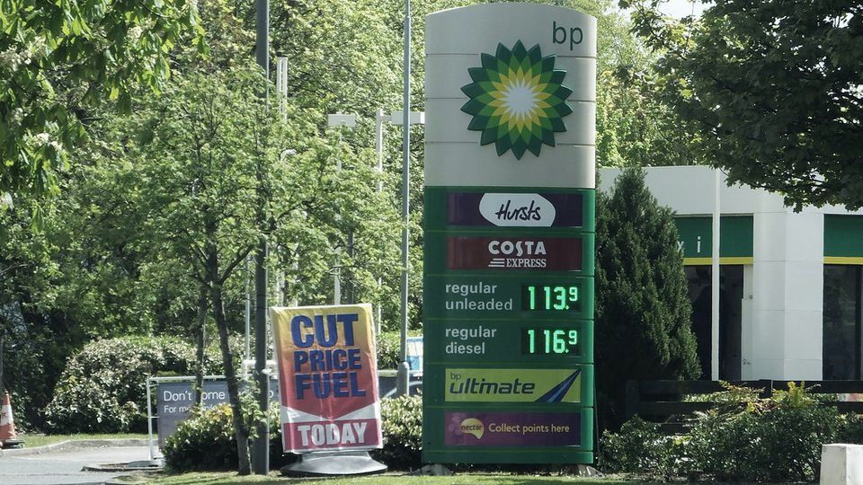 A roadside sign listing fuel prices