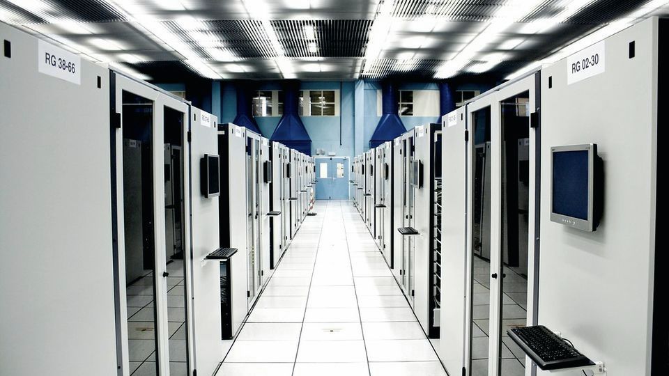 A long aisle of server racks in a data centre