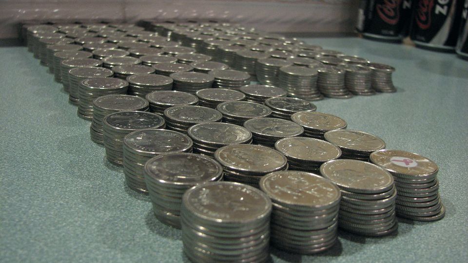 Rows of coin stacks laid out on a table