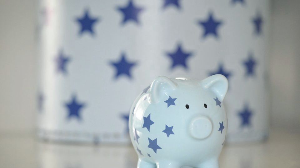 A small blue piggy bank decorated with stars