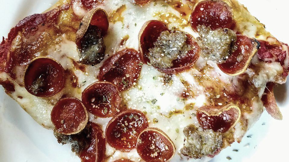 A pizza cut into equal square slices